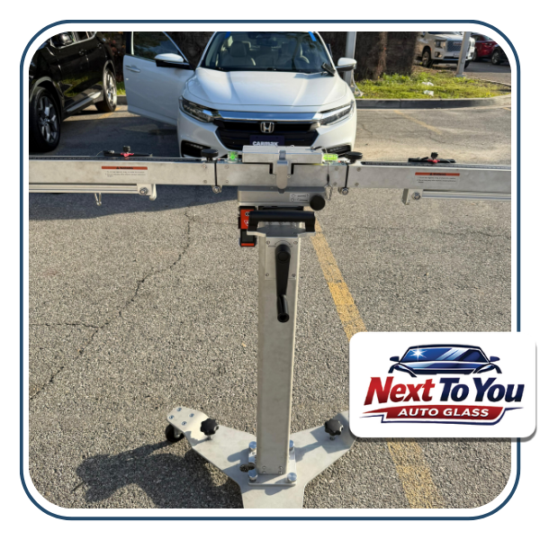 Mobile technician performing windshield replacement in Santa Ana driveway