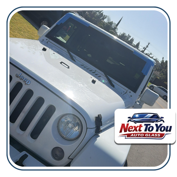 Technician performing windshield replacement in Orange, CA at a customer’s driveway.