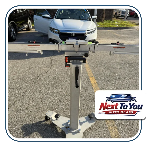 Mobile technician performing windshield replacement in Santa Ana driveway